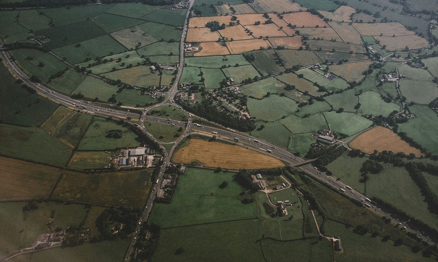 Aerial view of a country road cutting through farmland