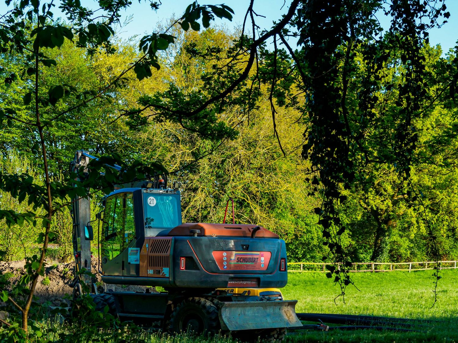 Tracked mulcher clearing scrub on a wooded bank