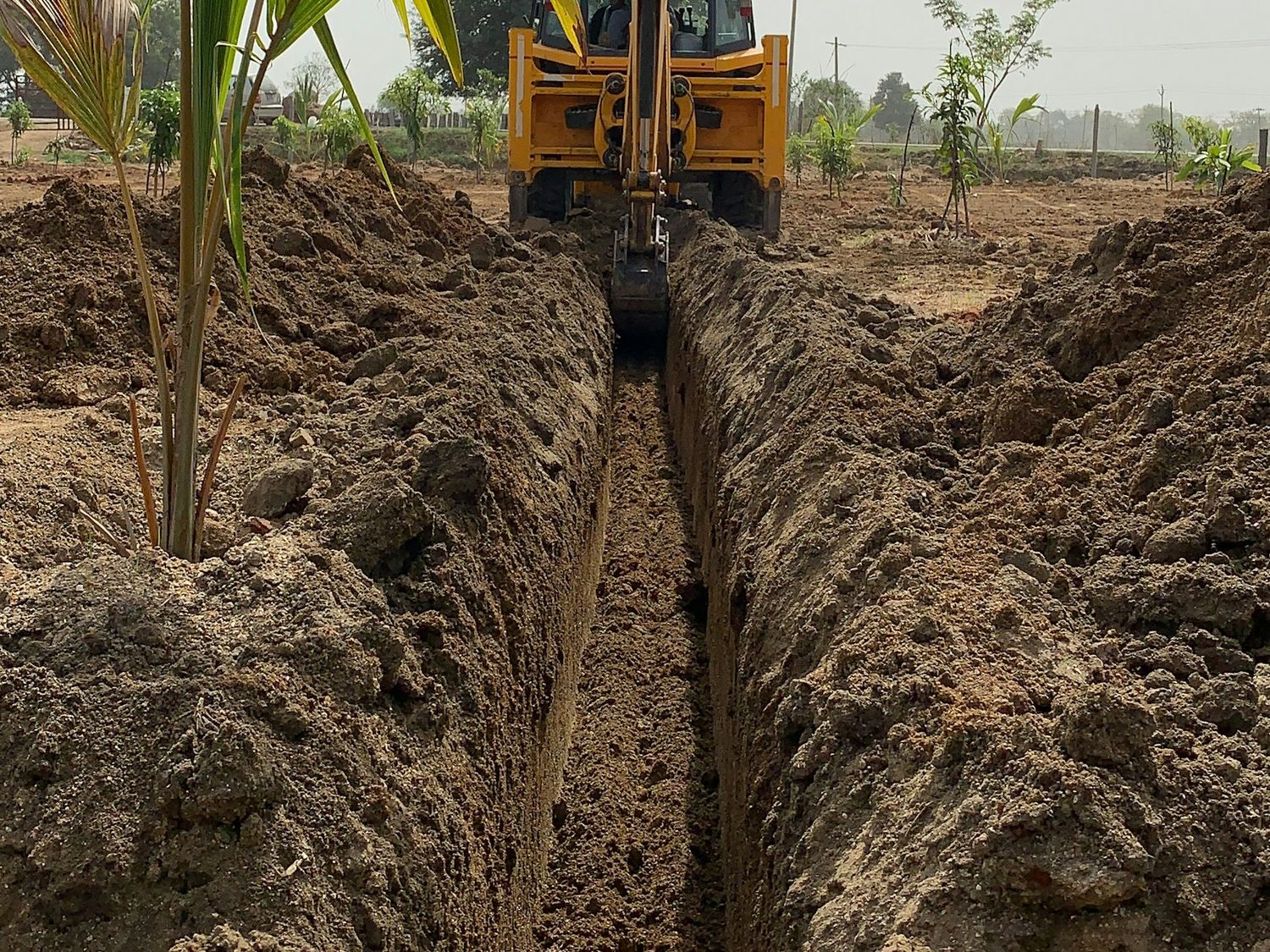 Trench dug across a field for a new land drain